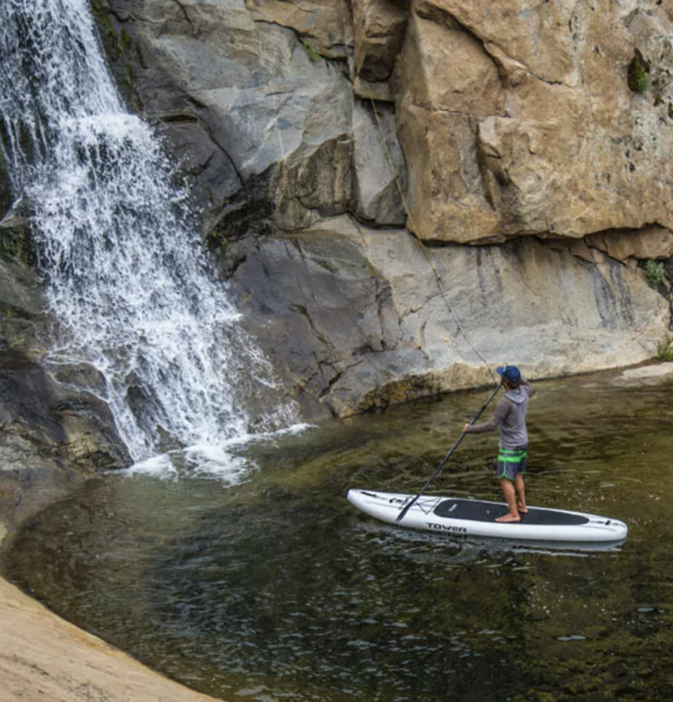 waterfall and paddleboarder